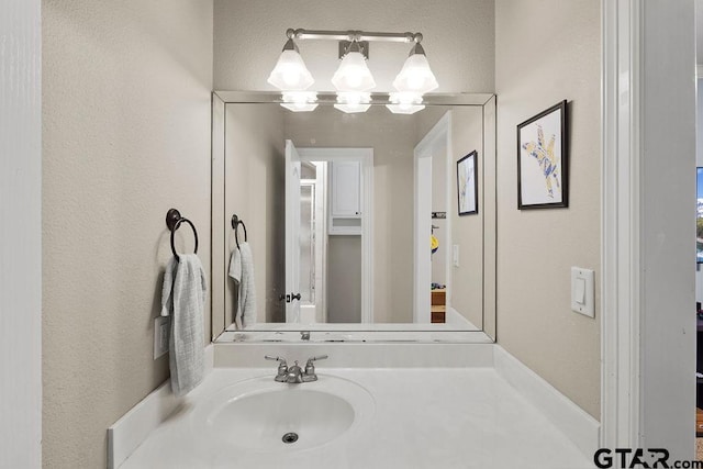 2322 Kingsmill Cir, Tyler, TX 75703 - bathroom featuring a chandelier, vanity, and a textured wall