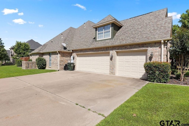 2322 Kingsmill Cir, Tyler, TX 75703 - view of front of home featuring concrete driveway, a garage, a front yard, a shingled roof, and brick siding