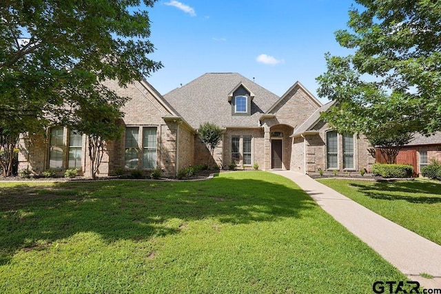 2322 Kingsmill Cir, Tyler, TX 75703 - french country style house featuring a front lawn and brick siding
