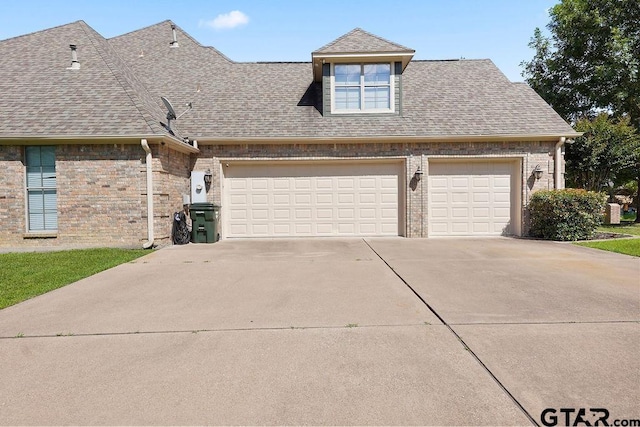 2322 Kingsmill Cir, Tyler, TX 75703 - view of front facade with concrete driveway, roof with shingles, an attached garage, and brick siding