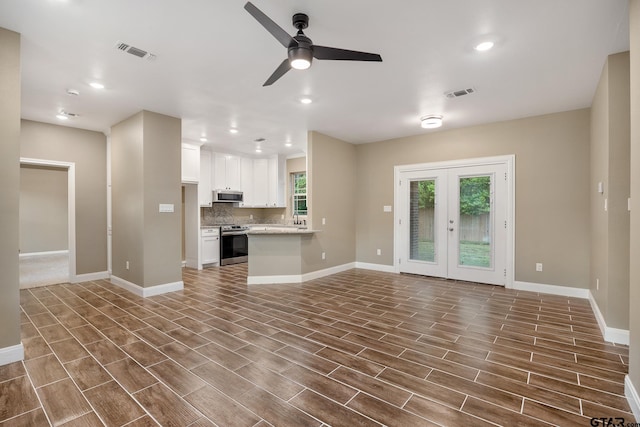 1720 Outer Dr, Tyler, TX 75701 - unfurnished living room with a ceiling fan, dark wood-style flooring, french doors, and recessed lighting