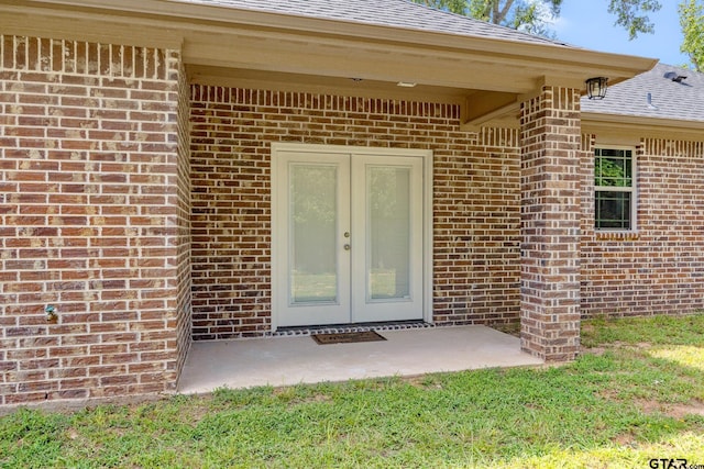 1720 Outer Dr, Tyler, TX 75701 - entrance to property with brick siding, french doors, and a shingled roof
