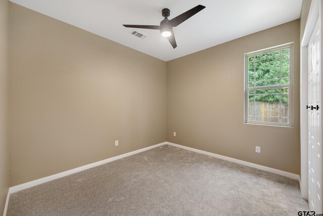 1720 Outer Dr, Tyler, TX 75701 - carpeted spare room featuring baseboards and a ceiling fan