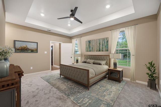 1720 Outer Dr, Tyler, TX 75701 - bedroom featuring carpet floors, a raised ceiling, multiple windows, and recessed lighting