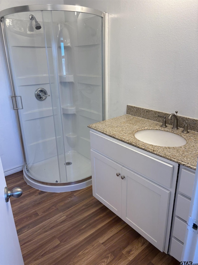 17215 Tartlon Rd, Mabank, TX 75147 - bathroom with vanity, a shower stall, and wood finished floors