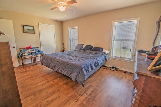 17215 Tartlon Rd, Mabank, TX 75147 - bedroom featuring wood finished floors, multiple windows, and a ceiling fan