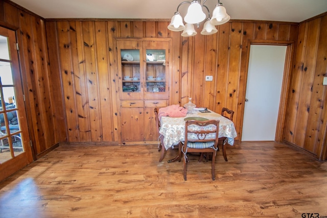 17215 Tartlon Rd, Mabank, TX 75147 - dining area with a chandelier, wood finished floors, and wooden walls