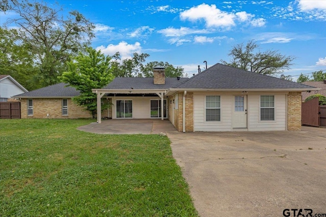 1216 Kingspark Dr, Tyler, TX 75703 - view of front facade with a chimney, a patio area, brick siding, and fence