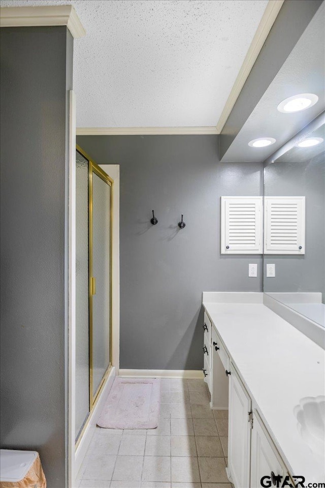 1216 Kingspark Dr, Tyler, TX 75703 - bathroom with a stall shower, tile patterned floors, crown molding, baseboards, and vanity