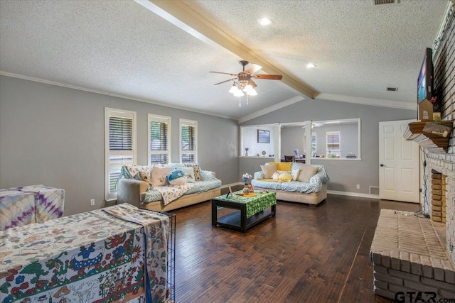 1216 Kingspark Dr, Tyler, TX 75703 - living area featuring a ceiling fan, lofted ceiling with beams, a brick fireplace, a textured ceiling, and hardwood / wood-style flooring