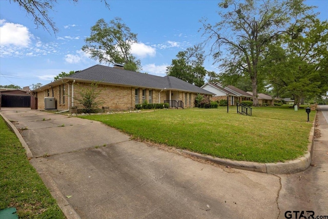 1216 Kingspark Dr, Tyler, TX 75703 - ranch-style house with brick siding, driveway, and a front yard