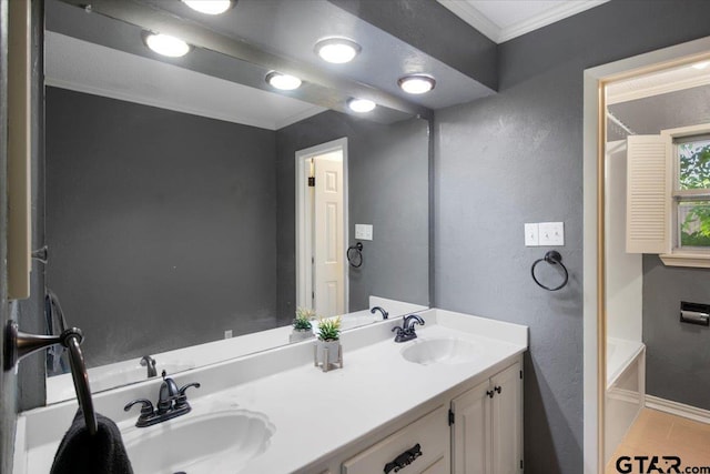 1216 Kingspark Dr, Tyler, TX 75703 - bathroom with a textured wall, crown molding, a sink, and double vanity