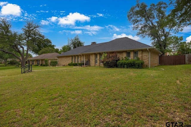 1216 Kingspark Dr, Tyler, TX 75703 - ranch-style house featuring a front lawn, brick siding, and fence