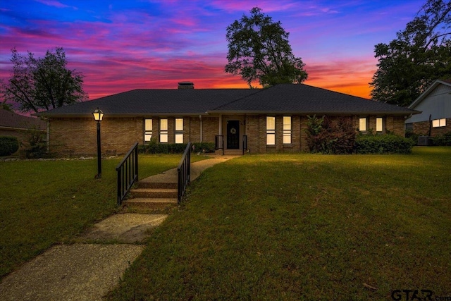 1216 Kingspark Dr, Tyler, TX 75703 - ranch-style home featuring brick siding, a chimney, and a lawn