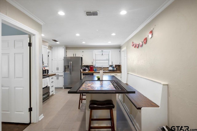 1216 Kingspark Dr, Tyler, TX 75703 - dining space featuring ornamental molding, visible vents, and recessed lighting
