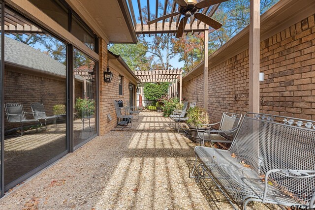 view of patio / terrace with ceiling fan and a pergola