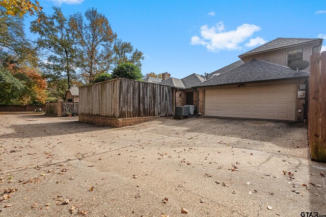 view of home's exterior featuring central AC unit and a garage