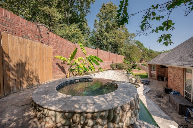 view of patio / terrace featuring a jacuzzi