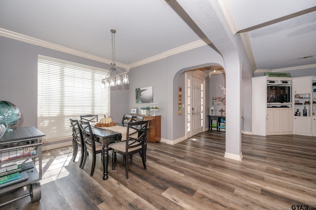 dining area featuring dark hardwood / wood-style flooring and ornamental molding