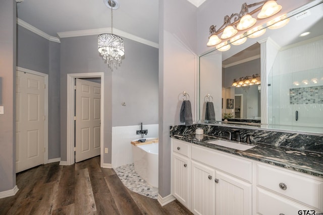 bathroom featuring lofted ceiling, hardwood / wood-style floors, vanity, ornamental molding, and separate shower and tub