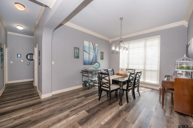 dining room featuring crown molding and dark hardwood / wood-style flooring