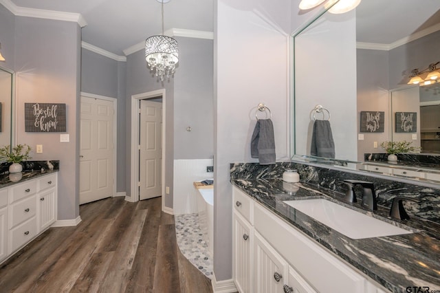 bathroom with crown molding, vanity, and hardwood / wood-style flooring