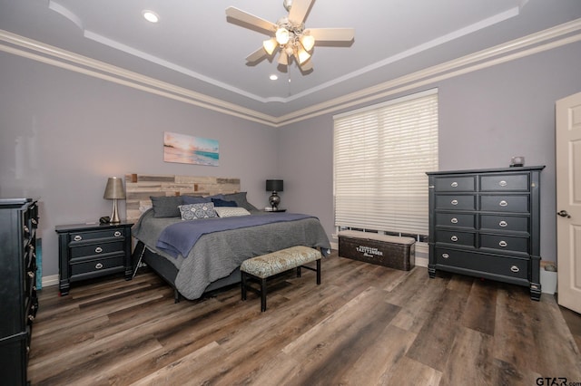 bedroom featuring a raised ceiling, crown molding, and dark hardwood / wood-style flooring