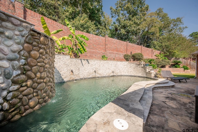 exterior space with a patio area and pool water feature