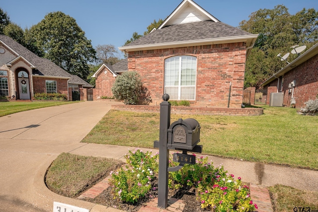 view of home's exterior with cooling unit and a lawn