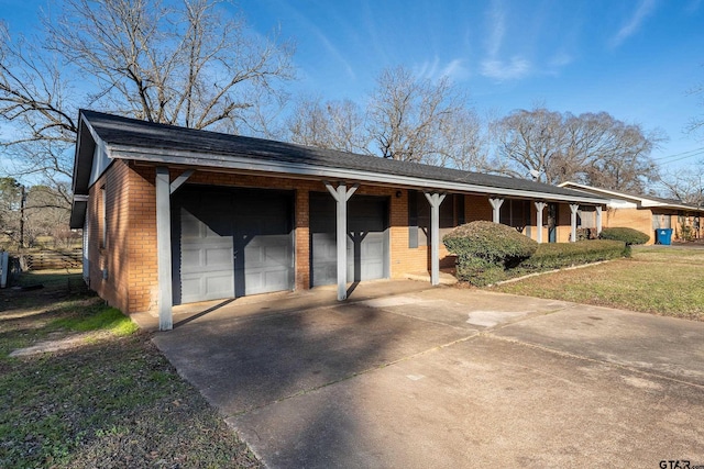 ranch-style home with a front yard, a porch, and a garage