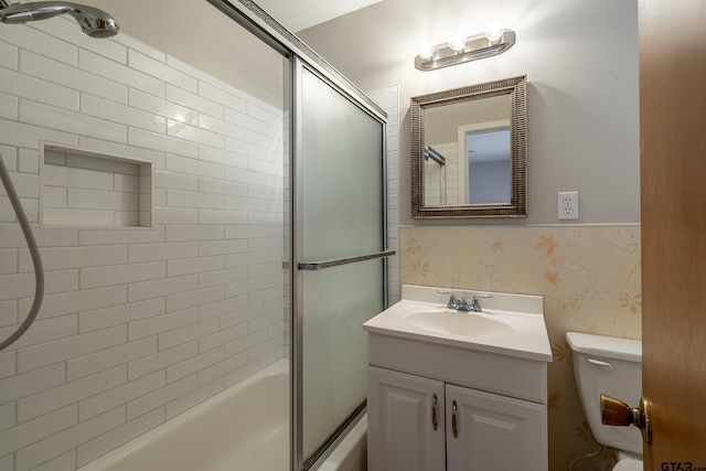 full bathroom with toilet, vanity, and combined bath / shower with glass door