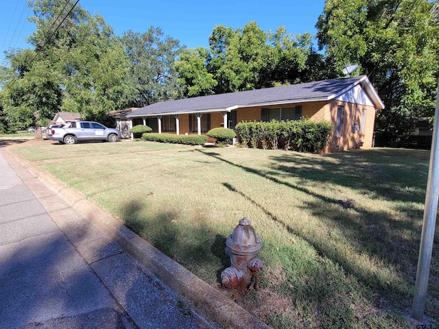 ranch-style home featuring a front yard