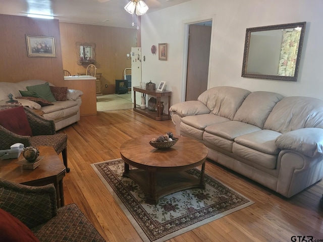 living room featuring hardwood / wood-style flooring and ceiling fan