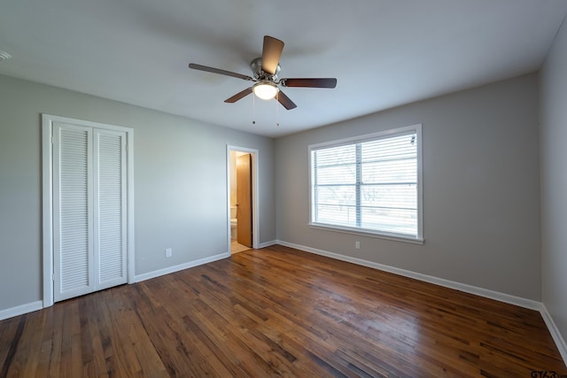 unfurnished bedroom with ceiling fan, dark hardwood / wood-style floors, connected bathroom, and a closet