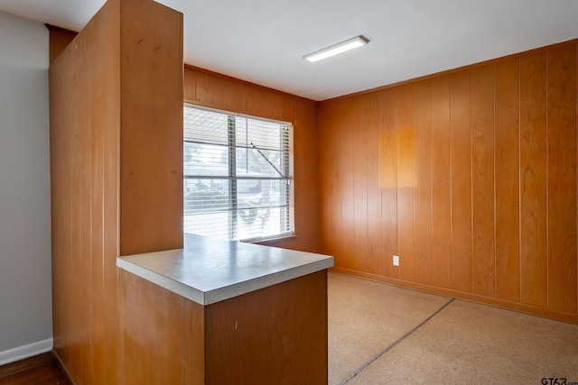 unfurnished office featuring wooden walls