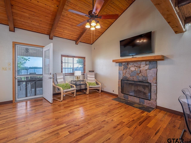 22090 Sportsmans Dr, Chandler, TX 75758 - living area with wood finished floors, wood ceiling, a stone fireplace, and baseboards