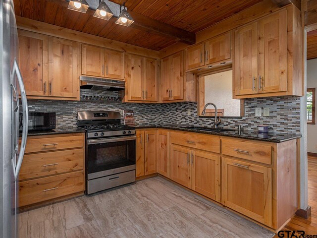22090 Sportsmans Dr, Chandler, TX 75758 - kitchen with appliances with stainless steel finishes, a sink, under cabinet range hood, wood ceiling with exposed beams, and backsplash