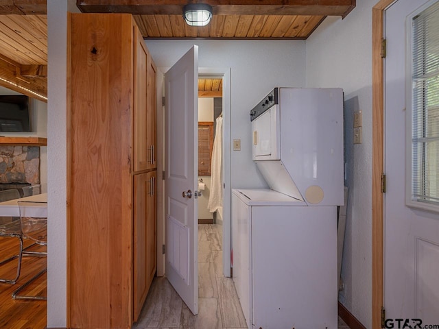 22090 Sportsmans Dr, Chandler, TX 75758 - washroom featuring stacked washing machine and dryer and wooden ceiling