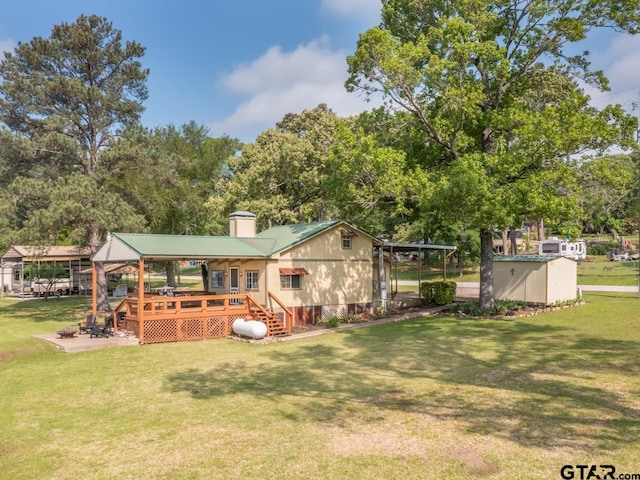 22090 Sportsmans Dr, Chandler, TX 75758 - rear view of property with a yard, a deck, view of wooded area, and a chimney