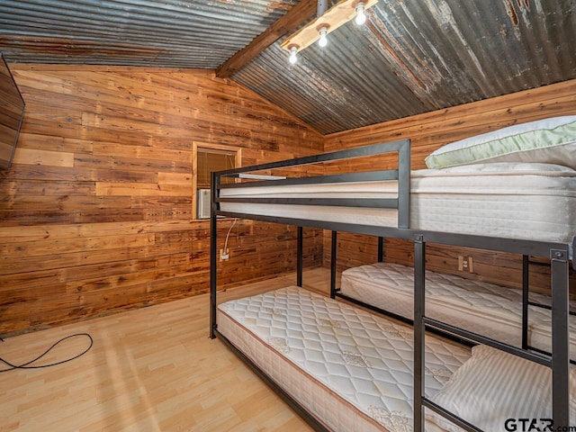 22090 Sportsmans Dr, Chandler, TX 75758 - unfurnished bedroom featuring wood walls and wood finished floors