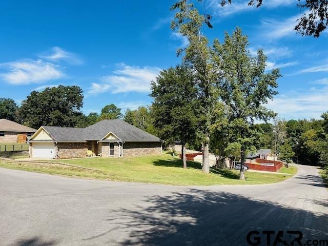 view of front of property featuring a garage and a front yard