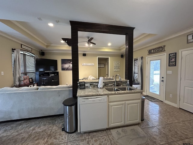 kitchen with crown molding, dishwasher, sink, and a raised ceiling