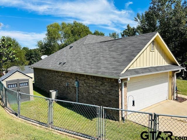 view of home's exterior featuring an outbuilding, a garage, and a yard