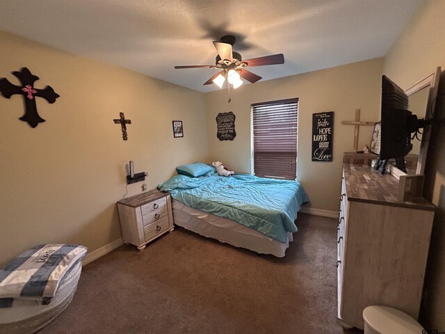 bedroom with dark carpet and ceiling fan