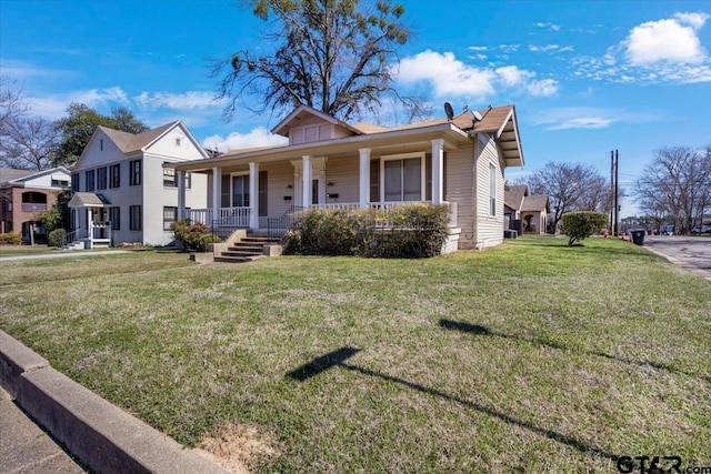 bungalow with a front yard and covered porch