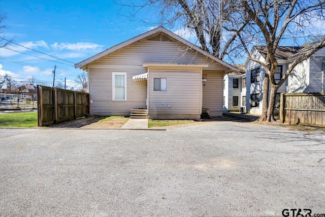 back of house with fence