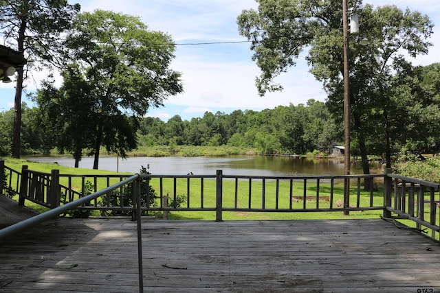 deck featuring a lawn and a water view