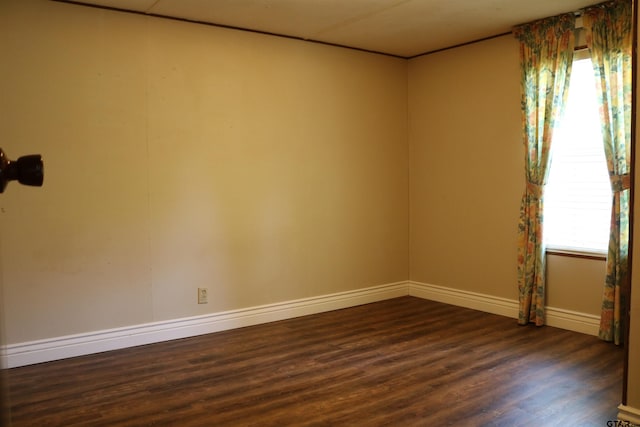 unfurnished room with dark wood-type flooring