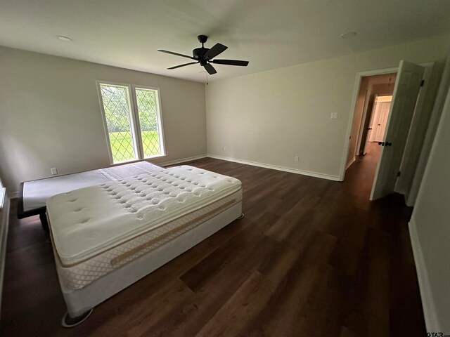 bedroom with ceiling fan and dark hardwood / wood-style floors