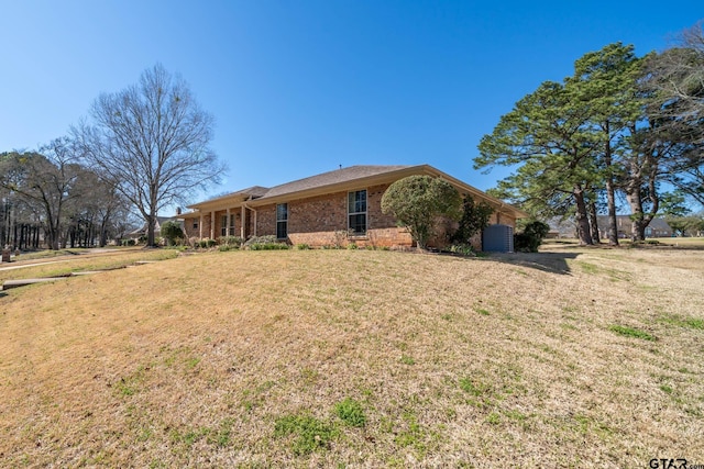 view of front of house with brick siding and a front yard